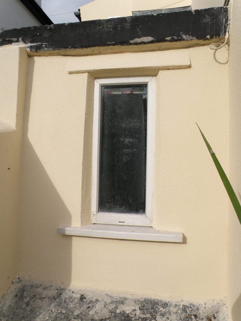Finished window with crisp new render surround and sill