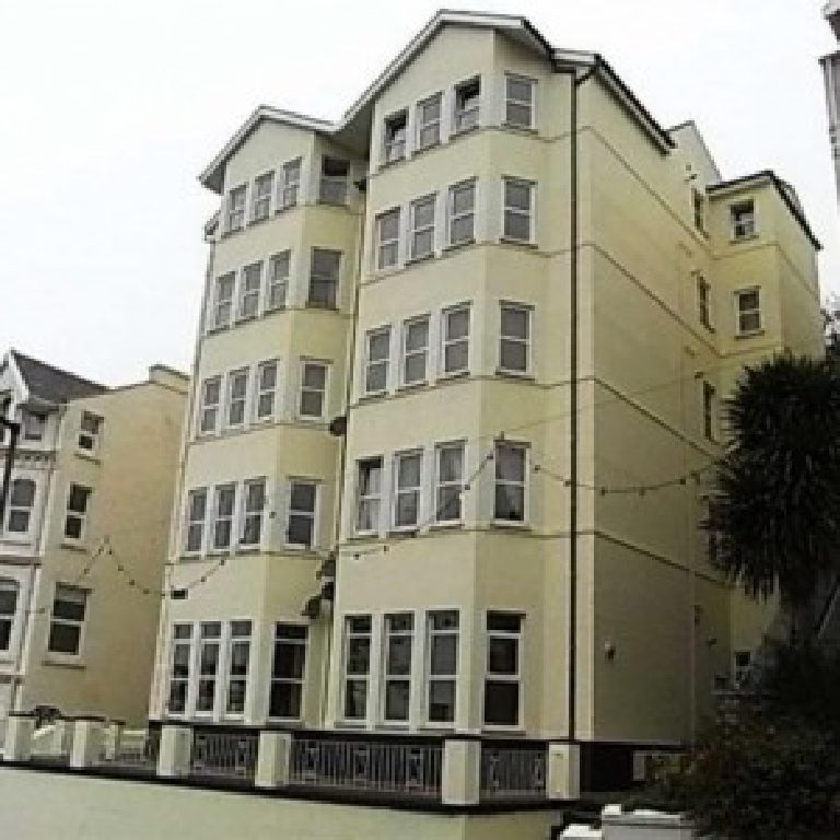 Falcon Cliff Apartments looking dull and weather-worn before the work