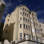 Looking up at the finished corner of Falcon Cliff Apartments in sunshine