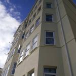Looking straight up the rendered facade of Falcon Cliff Apartments