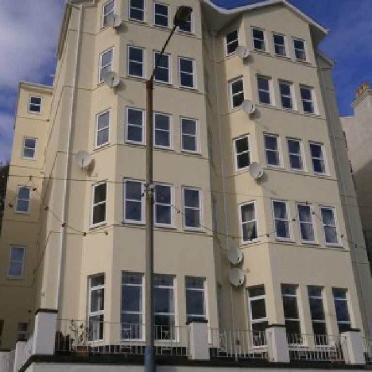 The full height of Falcon Cliff Apartments from street level