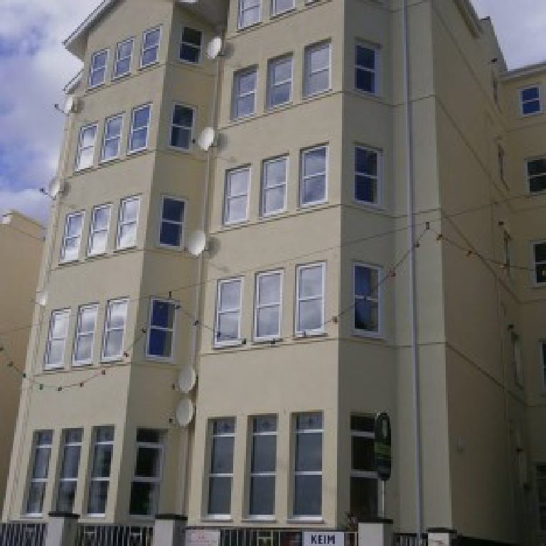 Finished elevation of Falcon Cliff Apartments with the Keim sign at the entrance