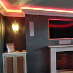 Finished Cadoro fire breast under red mood lighting in the home cinema