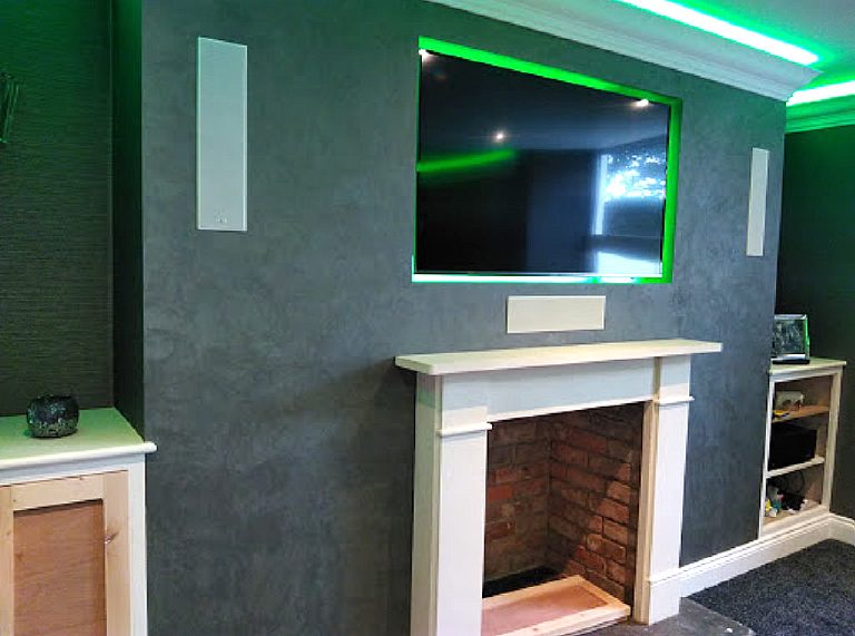 Finished fire breast with white surround, speakers and TV recess