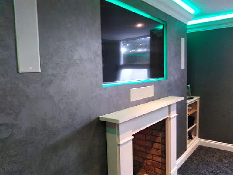 Angled view across the Cadoro wall to the fireplace and TV