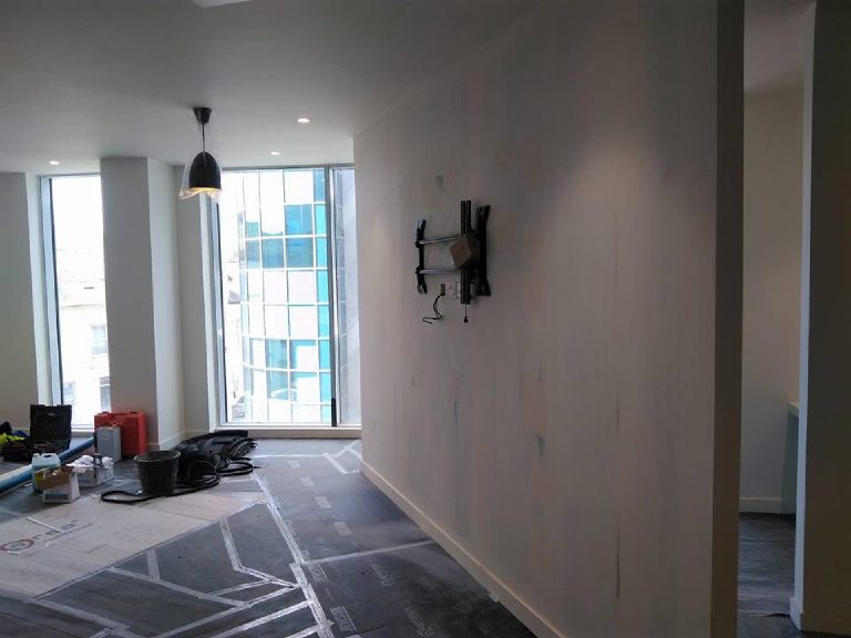 Bare feature wall awaiting its finish, floor protection down