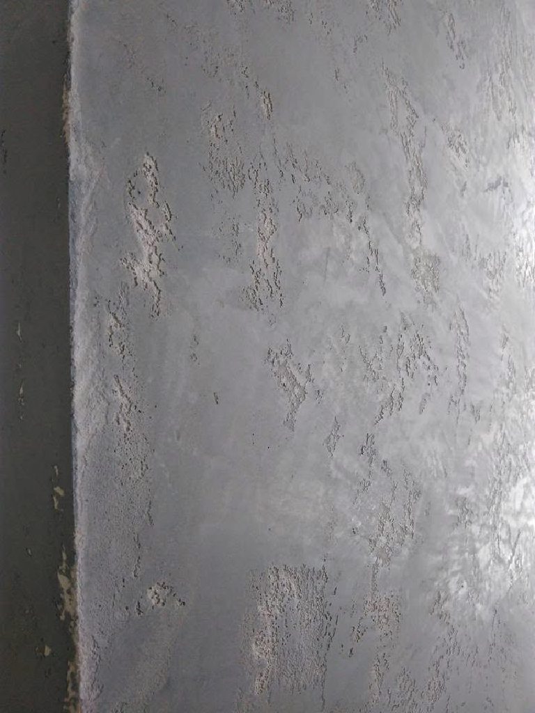 Weathered concrete texture detail at the wall edge