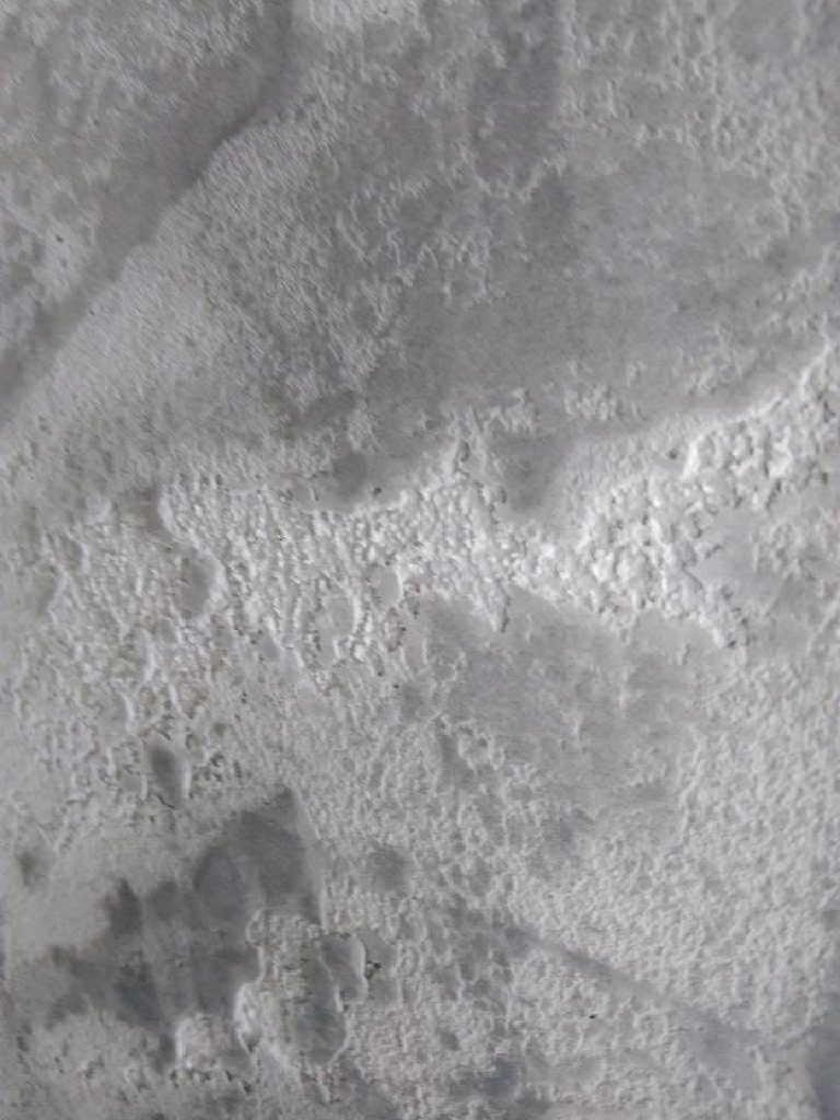 Pale weathered texture detail on the feature wall