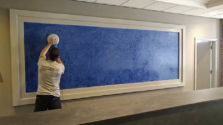 The panel above the new reception desk mid-polish