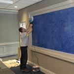 The framed blue feature panel above the reception desk