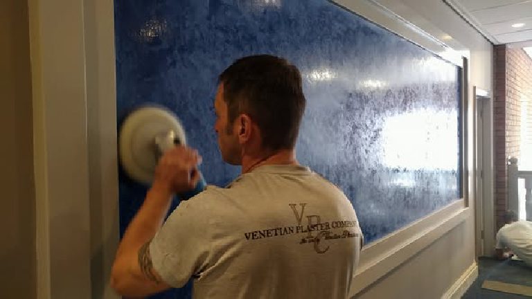 Working the polisher across the blue plaster