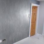 The silver Marmorino wall running the hall, pine doors either end