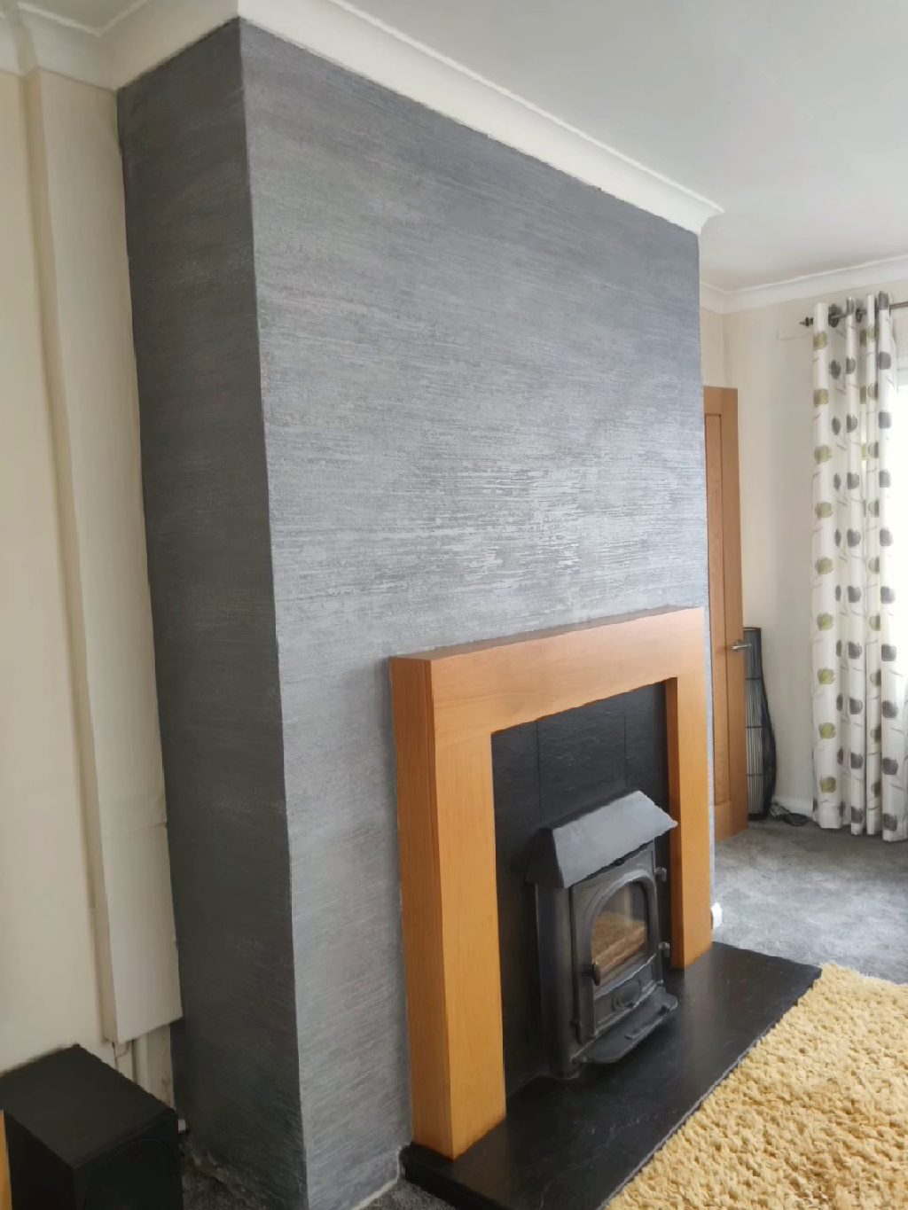 The fire breast from across the room, plain walls either side
