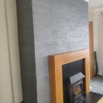 The fire breast from across the room, plain walls either side