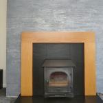 The finished fire breast in grey plaster, square on