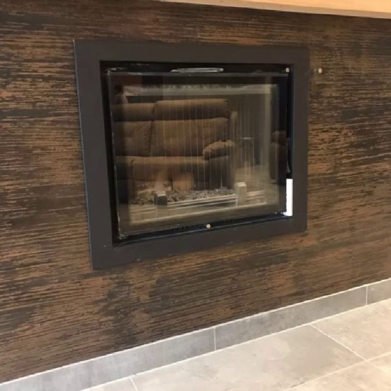 The recessed fire framed in the bronze texture
