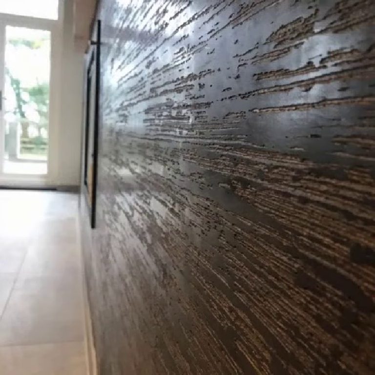 Daylight raking across the textured wall