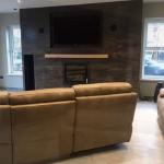 The media wall in the room, sofa in front