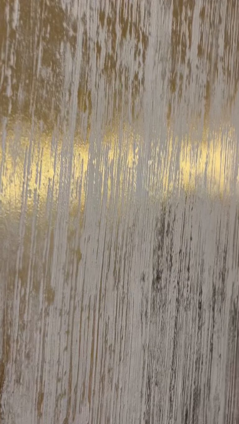 The combed texture close up, gold and dark shading running vertically