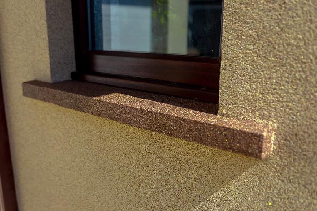 The window sill picked out in darker bronze Crystal Quartz against the sand-coloured wall