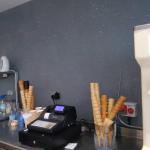 The charcoal glitter wall behind the counter, cones at the ready