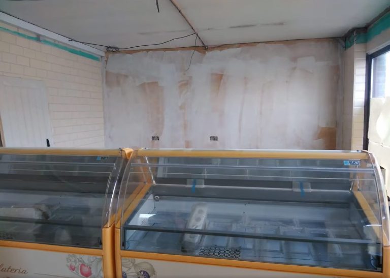 The feature wall skimmed and drying behind the cabinets
