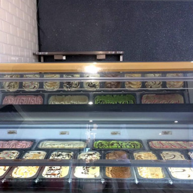 Ice cream cabinets against the glitter feature wall