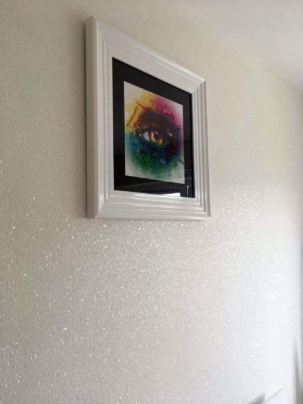 The rainbow eye picture on the sparkling white wall