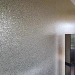 The champagne glitter wall lit from the window at the far end