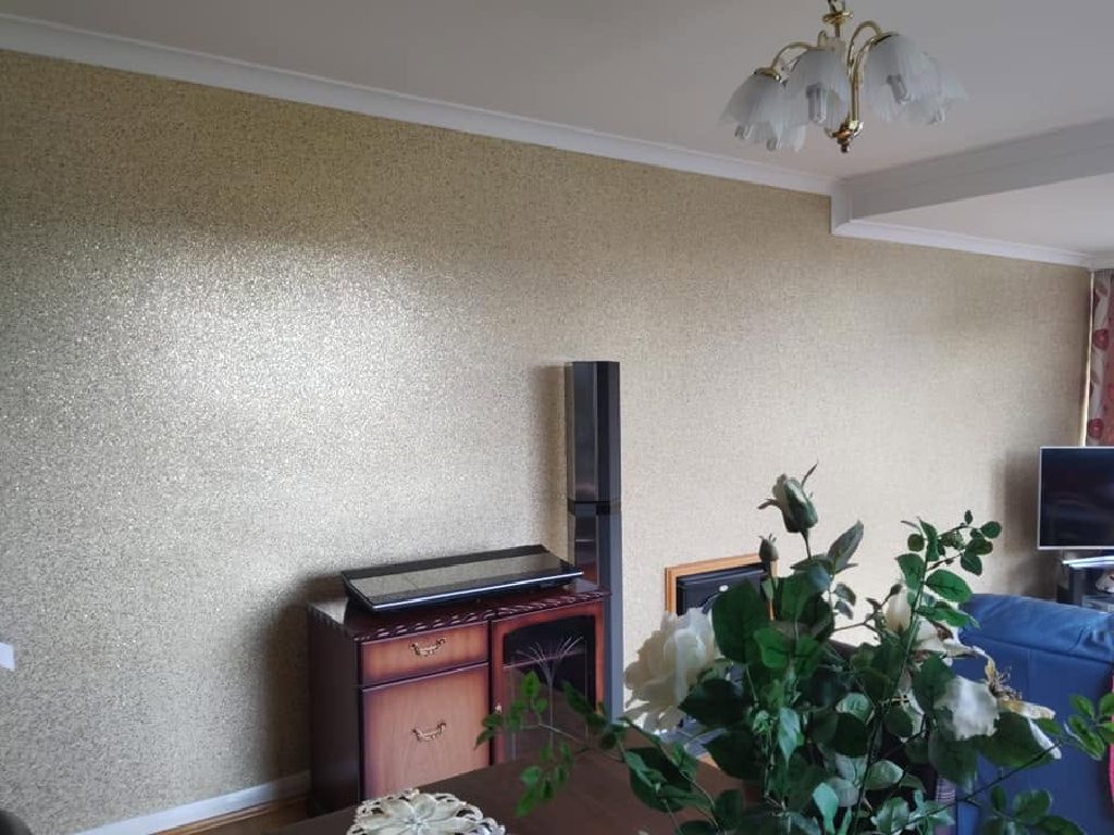 The finished glitter wall behind the fireplace and sideboard