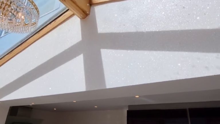 Shadows of the oak beams laid across the sparkling wall