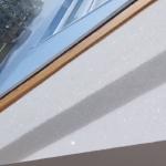 Sun raking across the glitter wall below the glazed roof, downlights below