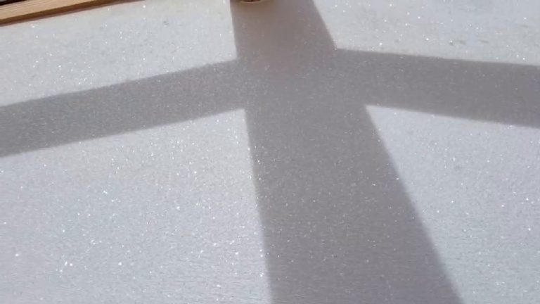 Close view of the fine white glitter with two beam shadows crossing it