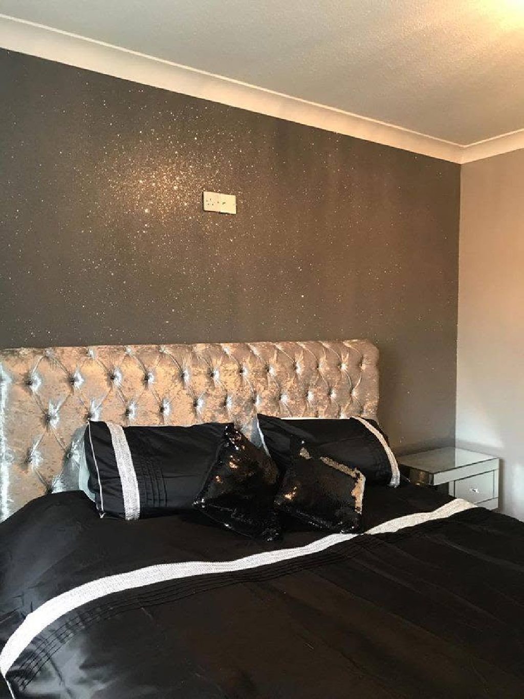 The grey glitter wall above the silver crushed velvet headboard
