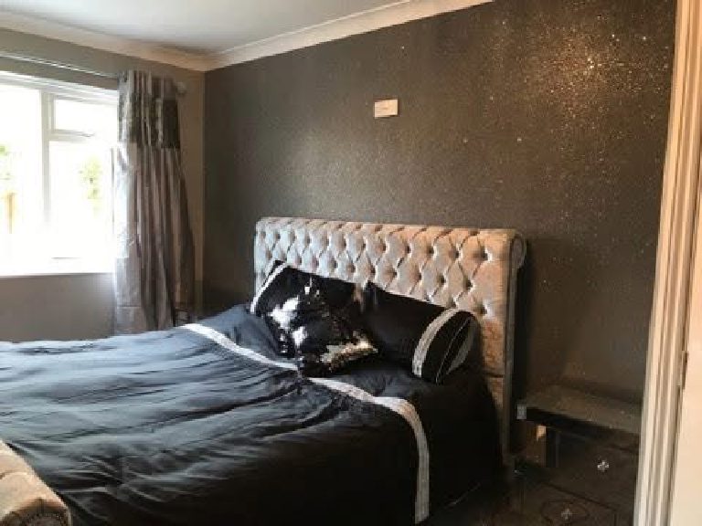 The full bedroom with the dark sparkling wall