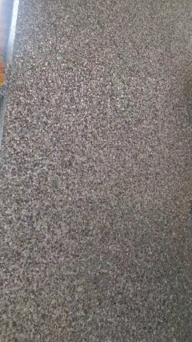 The grey glitter close up, with small points of colour from the holographic flake