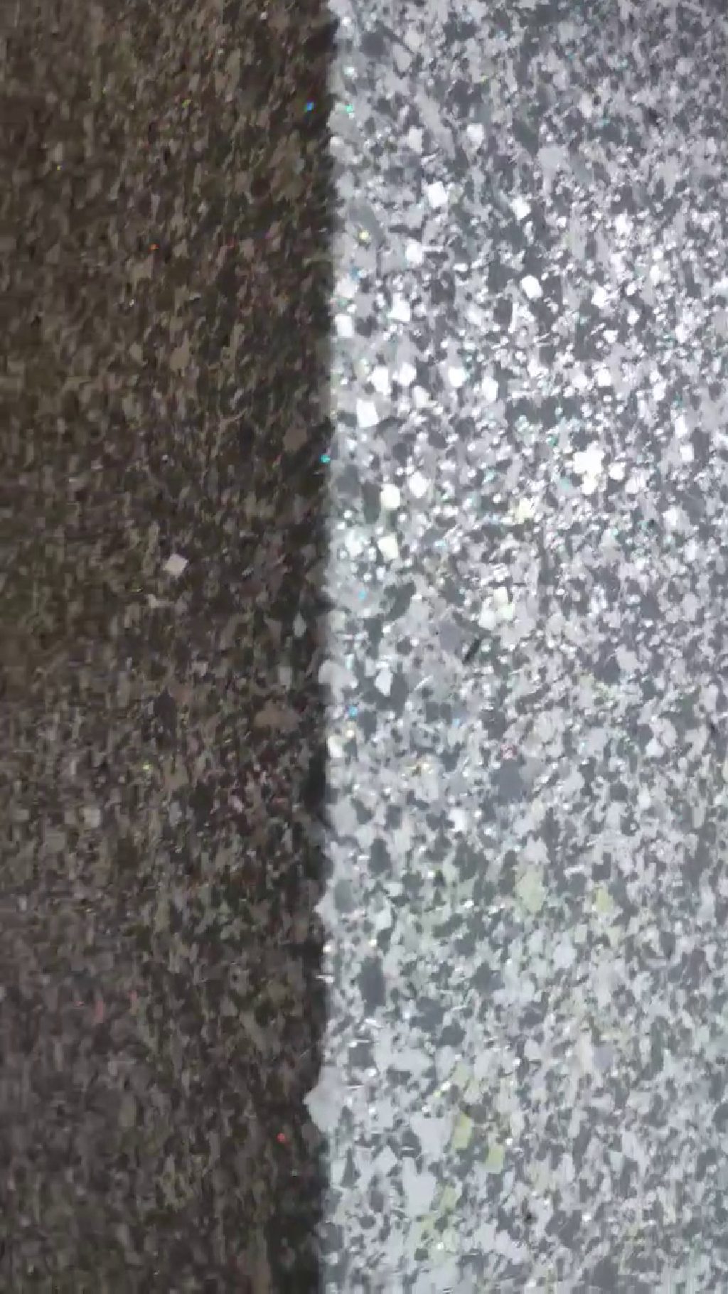 The corner of the wall with daylight raking across the glitter