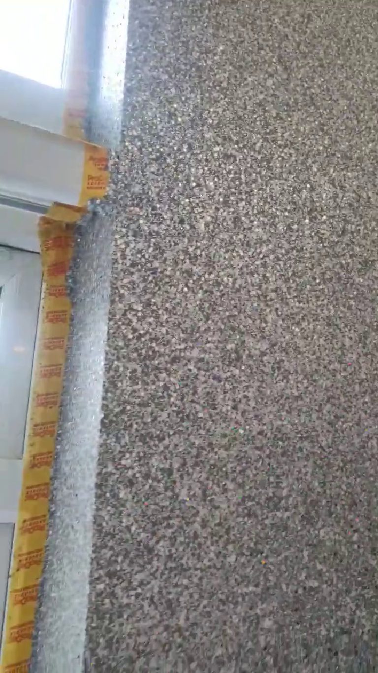 Tape protecting the window frame where the finish runs up to it