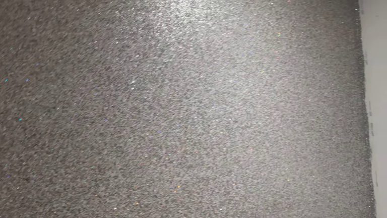 The sheen across the grey and silver glitter wall