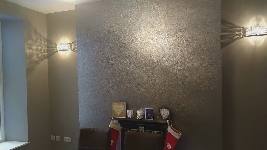 The fire breast glittering between the wall lights