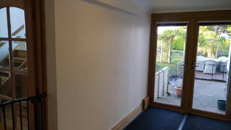 The plain painted wall by the garden doors before coating