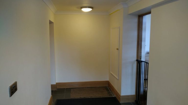 The hallway looking towards the front door before the finish