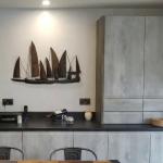 The Ilumitextra wall behind the dining table, between the tall units