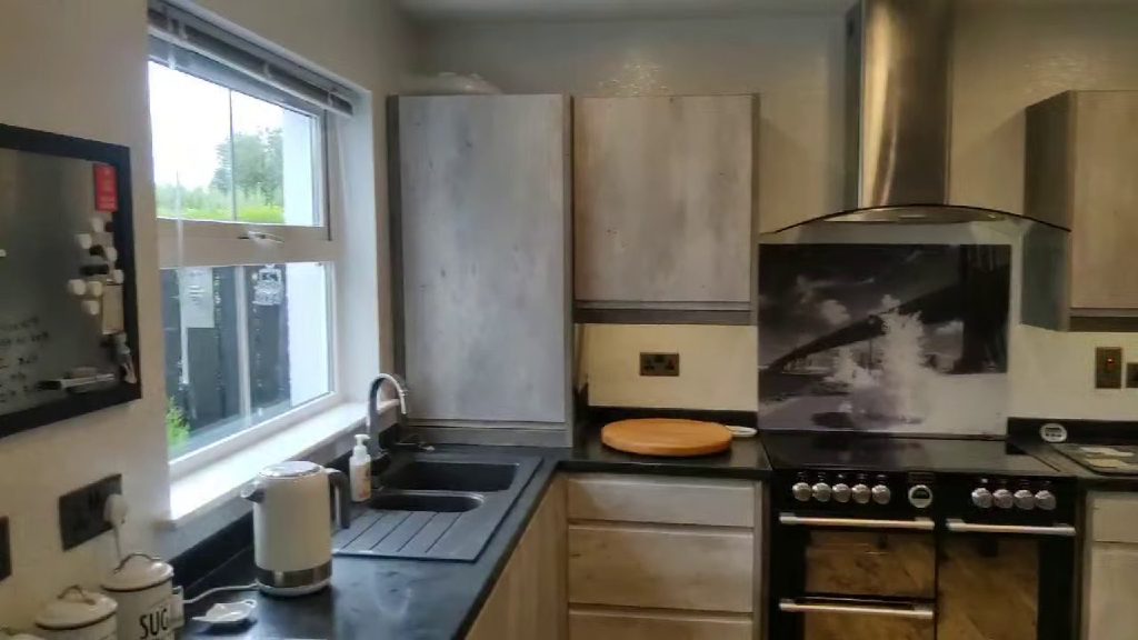 The kitchen looking across the sink to the range