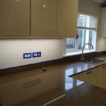 The plain painted wall behind the worktop before the finish