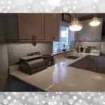 The glitter finish running behind the worktop under the pendant lights