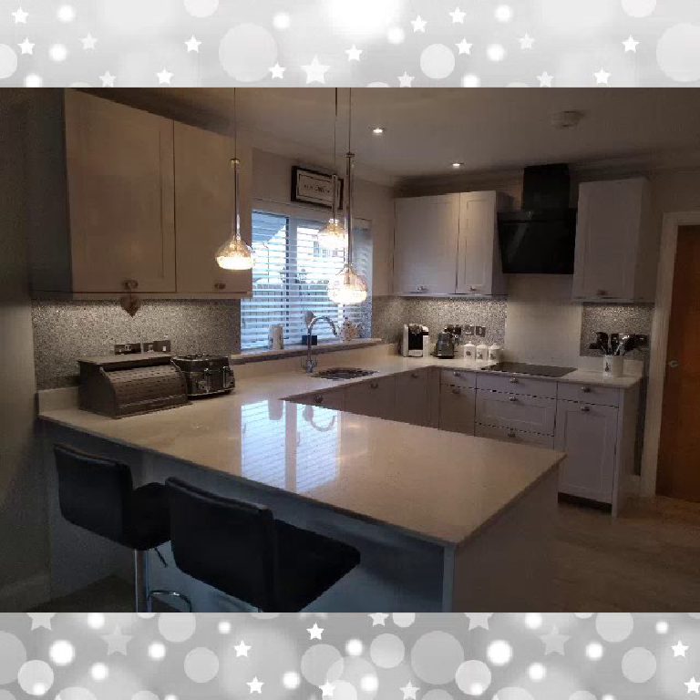 The whole kitchen with its glitter splashbacks and pendant lights