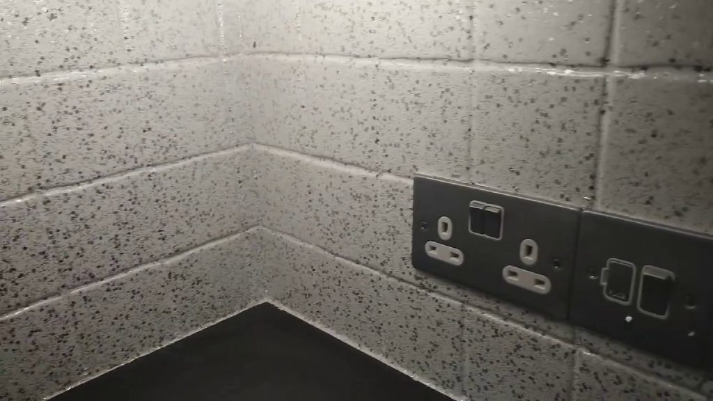 The white and silver glitter coating the tiled corner