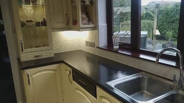 The kitchen with its glittered tiles under the cabinet lights