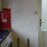 The finished wall running from the worktop round to the back door, full of fine sparkle